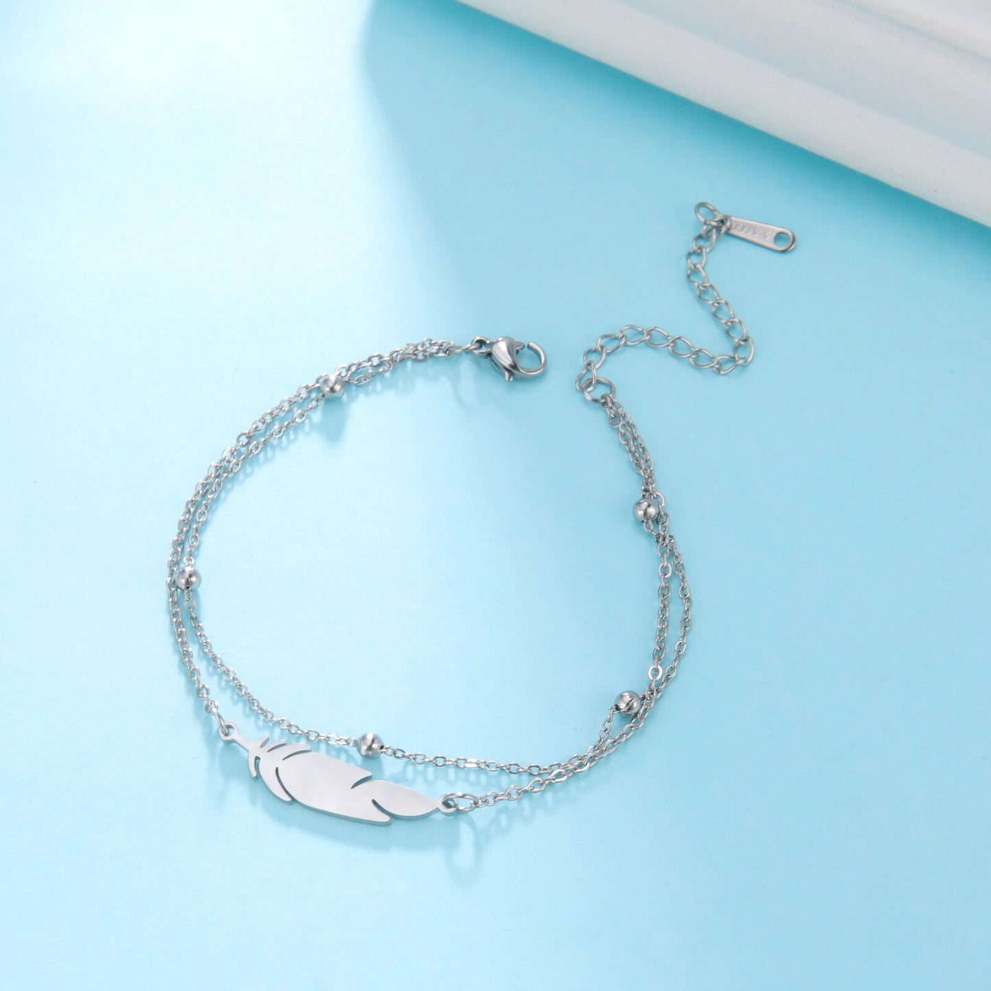 Ankle bracelet with a feather