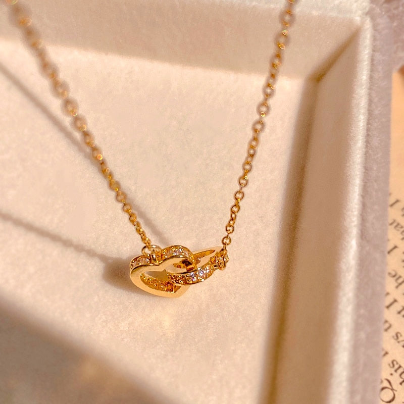 Necklace with a pendant in the form of connected hearts