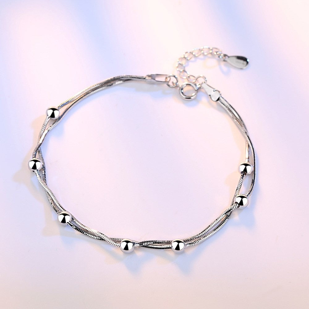 Silver bracelet with decorative pendants