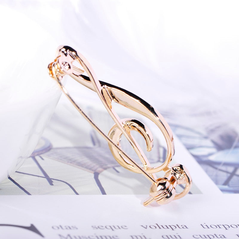 Treble clef brooch