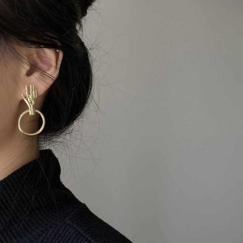 Earrings with a hand motif