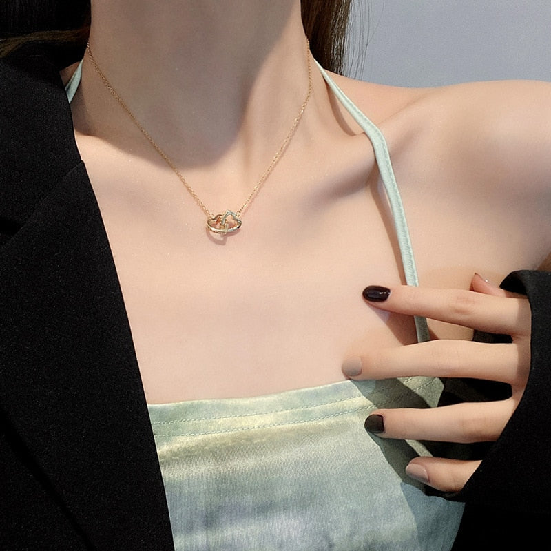 Necklace with a pendant in the form of connected hearts