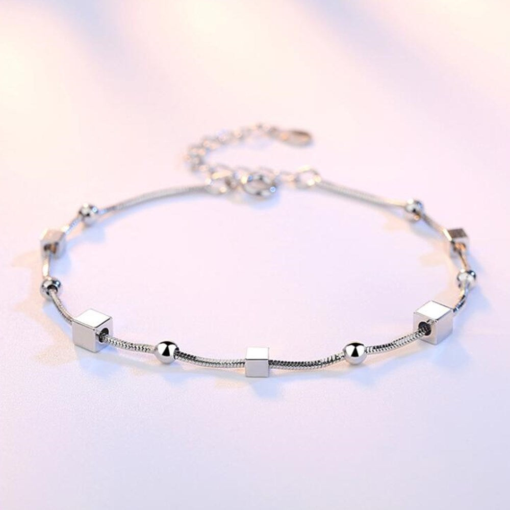 Silver bracelet with decorative pendants