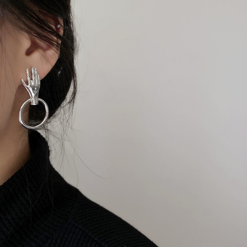 Earrings with a hand motif