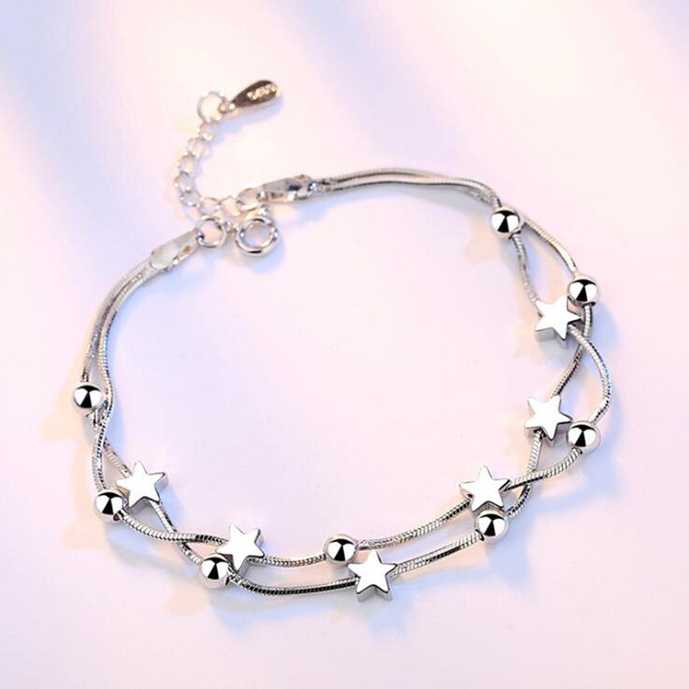 Silver bracelet with decorative pendants
