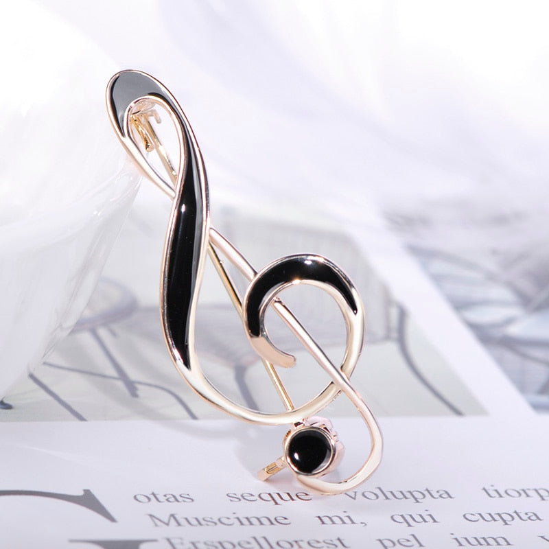 Treble clef brooch