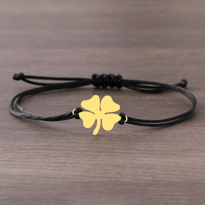 A bracelet on a thong with a four-leaf clover