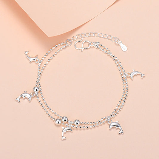 Bracelet with pendants in the shape of a dolphin