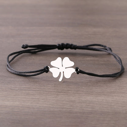 A bracelet on a thong with a four-leaf clover –